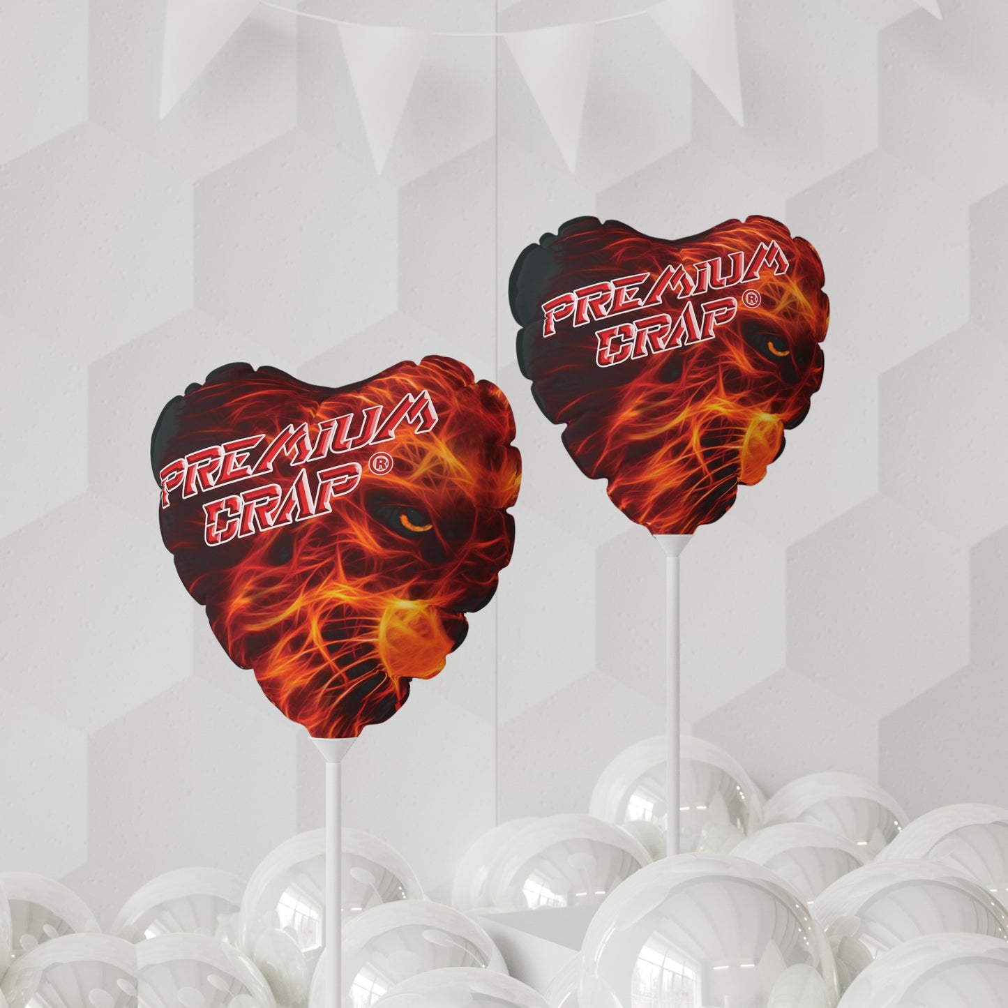 A round, red and black mylar balloon with the text 'PREMIUM CRAP' on it, displayed above a table with gift boxes and green plants in the background.