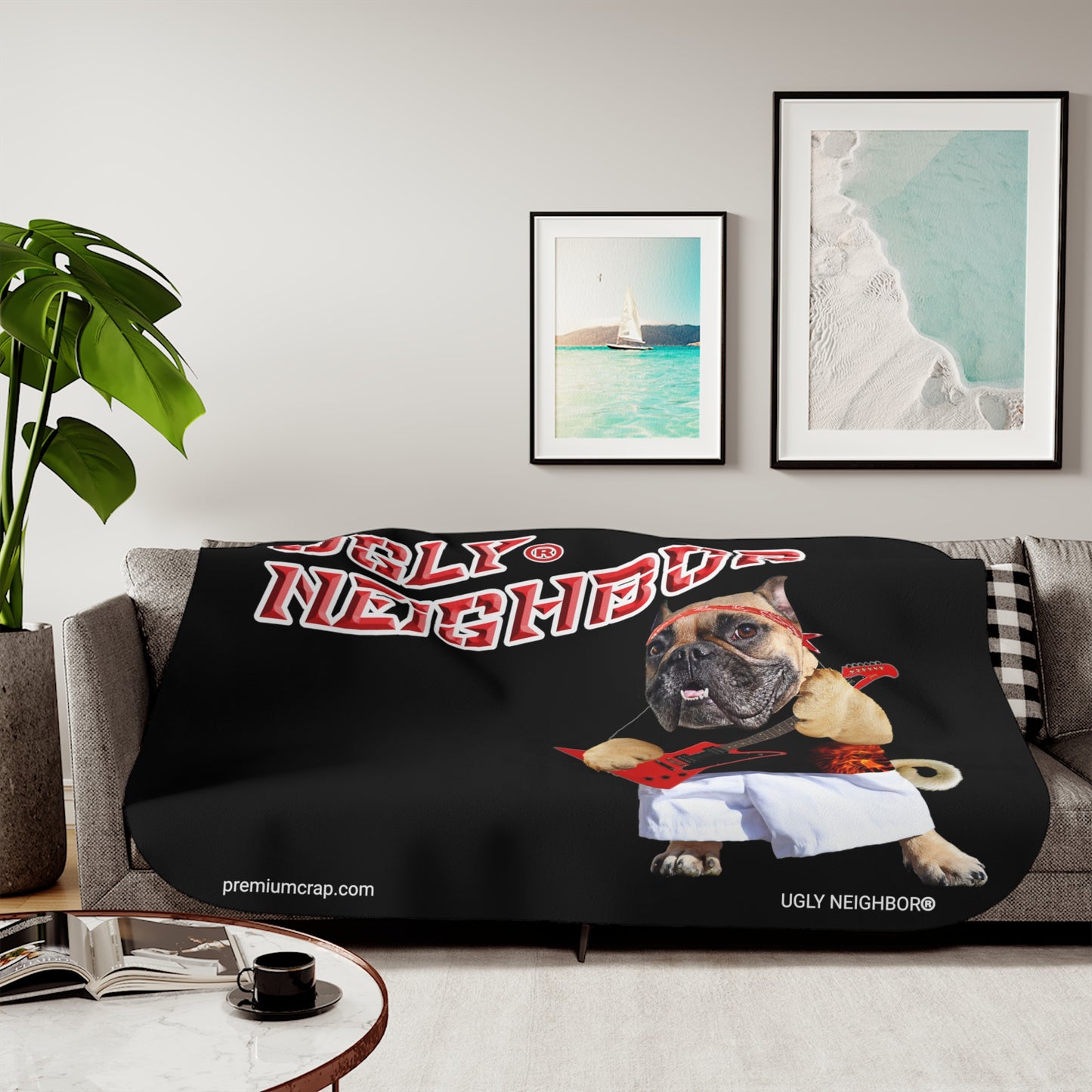 A Sherpa blanket with a graphic print of a dog character, draped over a couch in a living room setting.