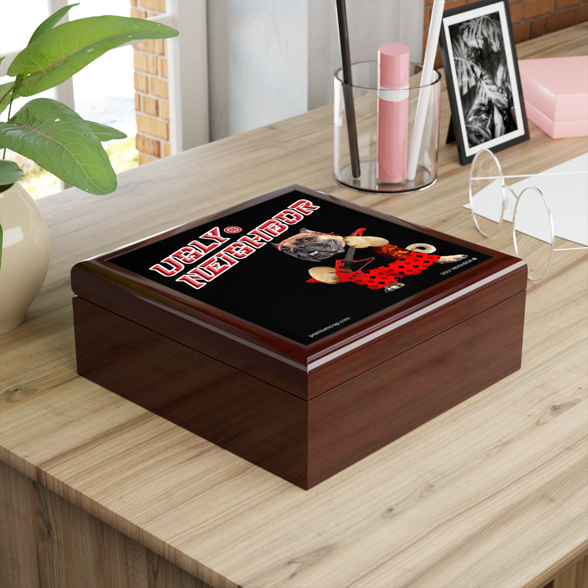 Wooden box with a 'Ugly Neighbor' design on a wooden surface