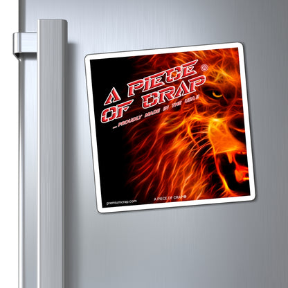 A square metal sign featuring a fiery lion graphic and the text 'A PIECE OF CRAP' is shown hanging on a silver refrigerator door next to the handle.