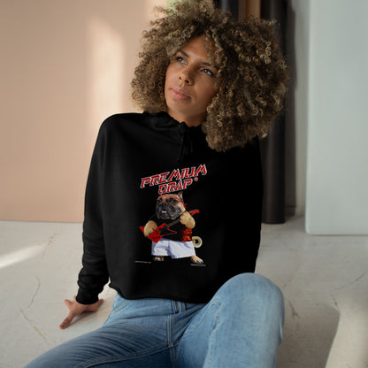 Person wearing a black hoodie with a graphic design sitting on a light-colored floor.