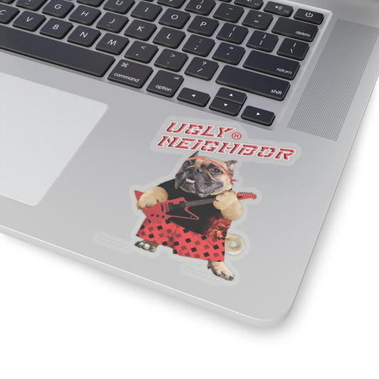 Laptop with a 'Ugly Neighbor' sticker featuring a dog holding a guitar on a white background