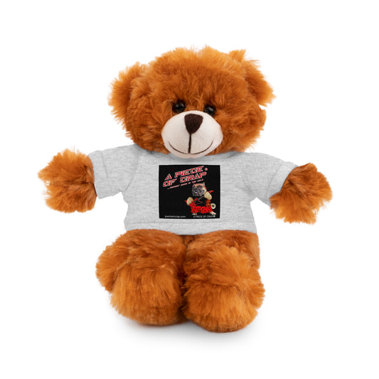 A brown plush teddy bear wearing a light gray t-shirt with a black graphic print that reads 'A PIECE OF CRAP'