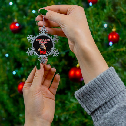 Person holding a snowflake-shaped ornament with a Christmas tree in the background