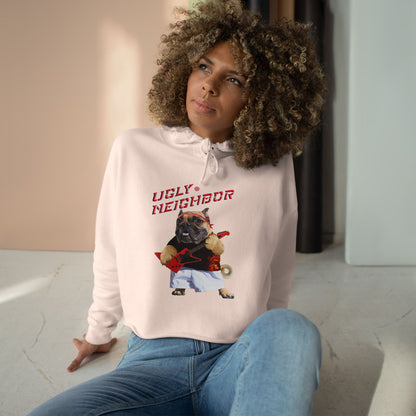 Person wearing a hoodie with a graphic design of a dog and text 'Ugly Neighbor' in a casual setting.