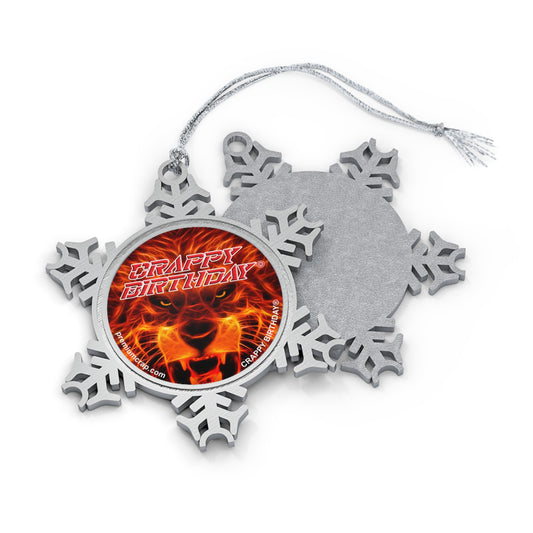 A silver snowflake-shaped Christmas ornament with a hanging string, shown with the front and back views overlapping on a white background. The front features a circular insert with a roaring lion face and the words 'CRAPPY BIRTHDAY' in red and orange.