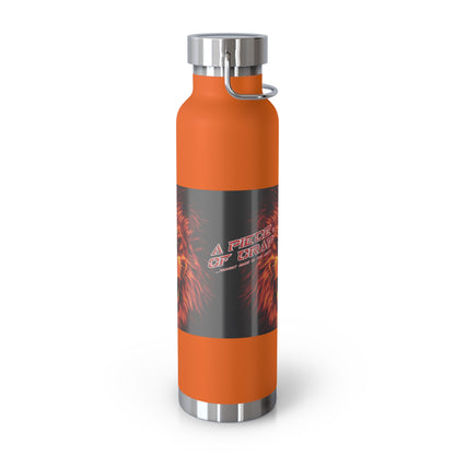 An orange insulated water bottle with a dark gray wrap label featuring red  flame graphics and the text 'A Piece Of Crap'. The bottle has a silver metal cap and base, and a silver loop handle, shown on a white background.