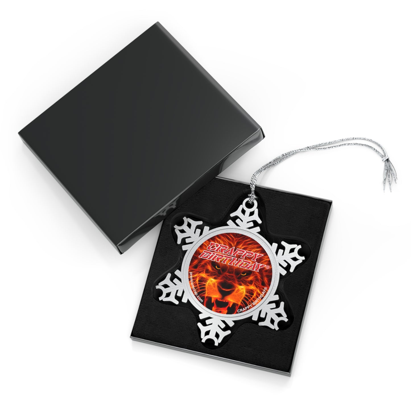 Decorative snowflake ornament with a portrait inside, on a black box with a white background
