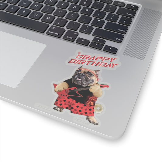 Laptop with a sticker of a dog in a bandana and 'Crappy Birthday' text.