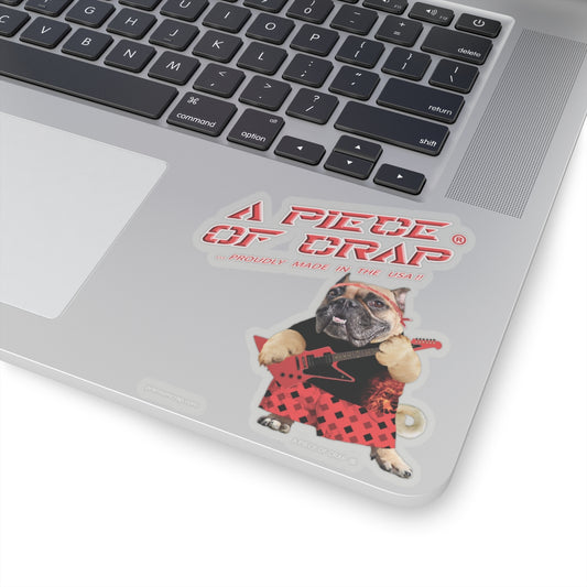Laptop with a sticker of a dog playing guitar and text 'A Piece of Crap' on the palm rest area.