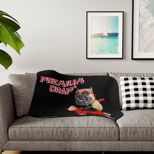Black blanket with a dog graphic and 'Premium Crap' text on a gray couch.