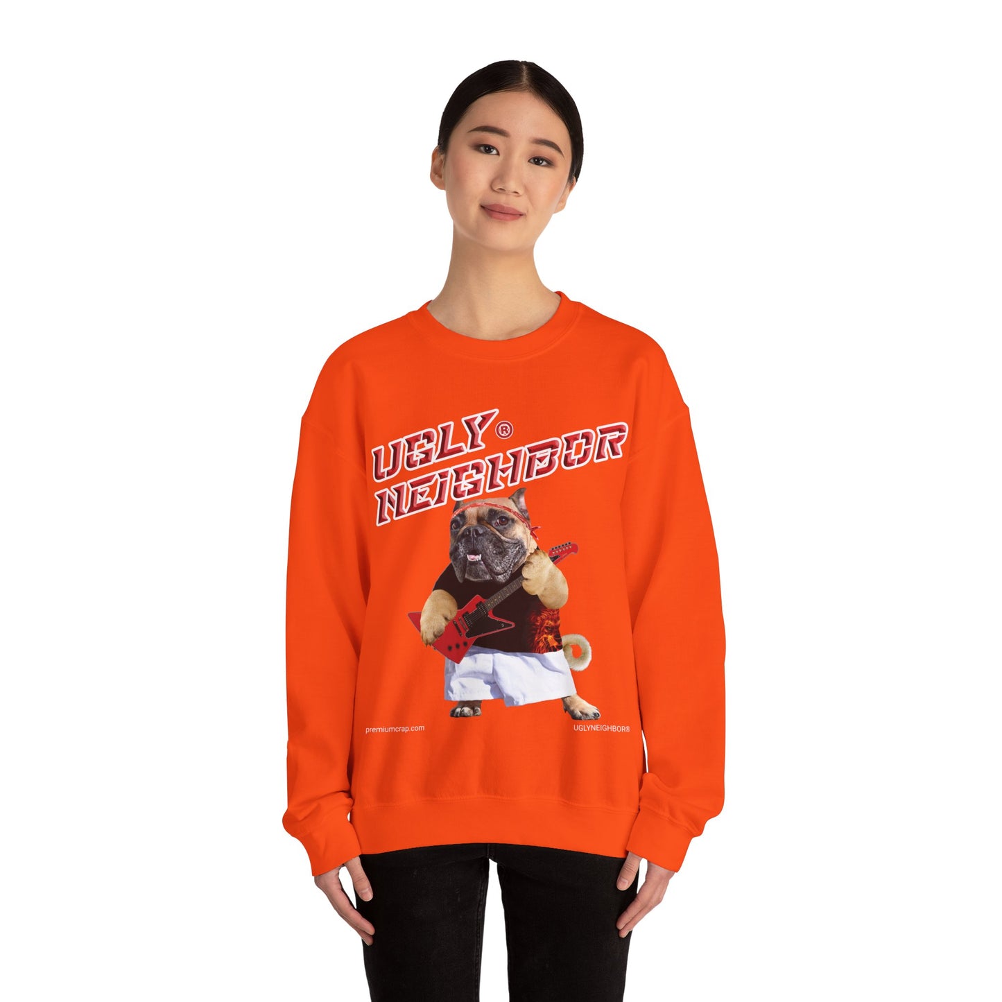Person wearing an orange sweatshirt with a graphic design on a white background
