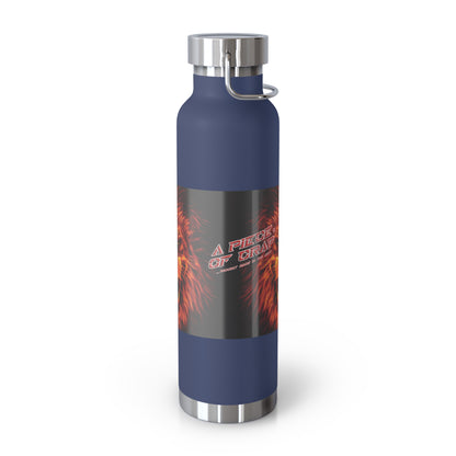 A reusable insulated bottle with a dark blue body, a black graphic label featuring red and orange flames and the text 'A Piece Of Crap', and stainless steel accents at the cap, base, and carrying loop, shown on a white background.