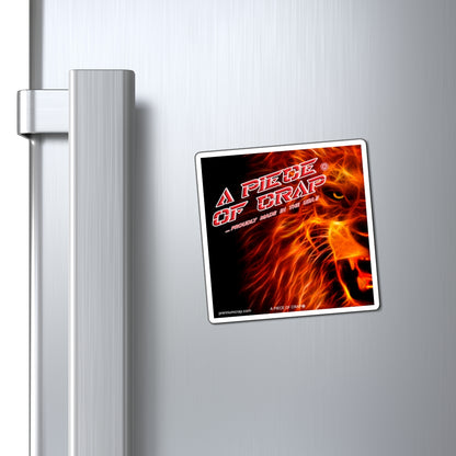 A square refrigerator magnet with a fiery lion graphic and the text 'A PIECE OF CRAP' is shown attached to a brushed stainless steel refrigerator door next to the handle.